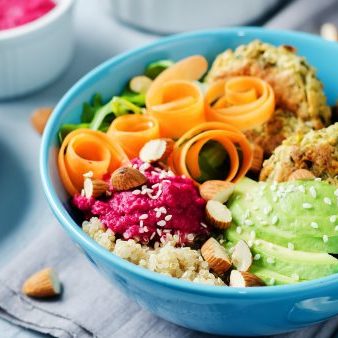 Quinoa Beet Hummus Falafel Bowl on a stone background. toning. selective focus; Shutterstock ID 785281864